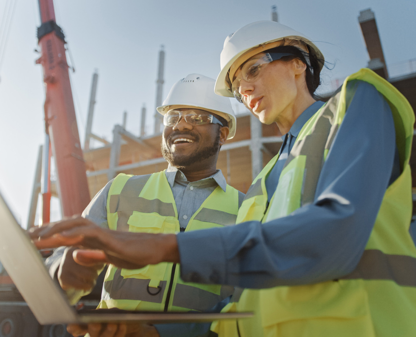 Construction Workers Looking At Laptop