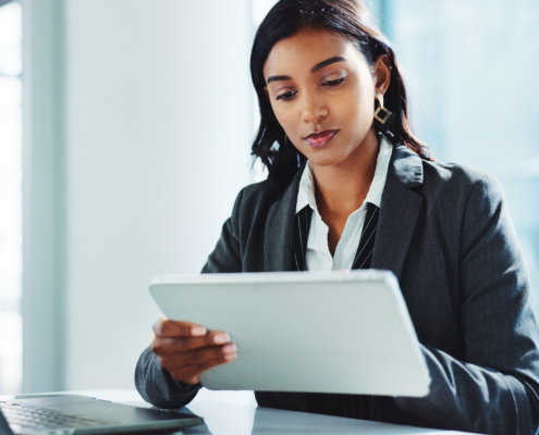 Professional In Office Looking At Tablet
