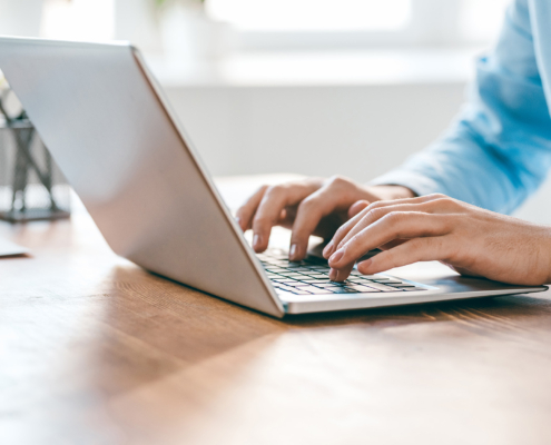 Hands Of Young Contemporary Office Manager Over Laptop Keypad During Work