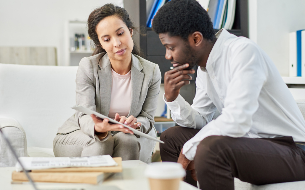 Two People Lookingat Clipboard