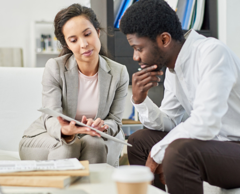 Two People Lookingat Clipboard