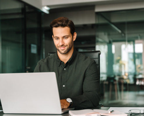 Young Business Man Working On Laptop Computer In Company Office