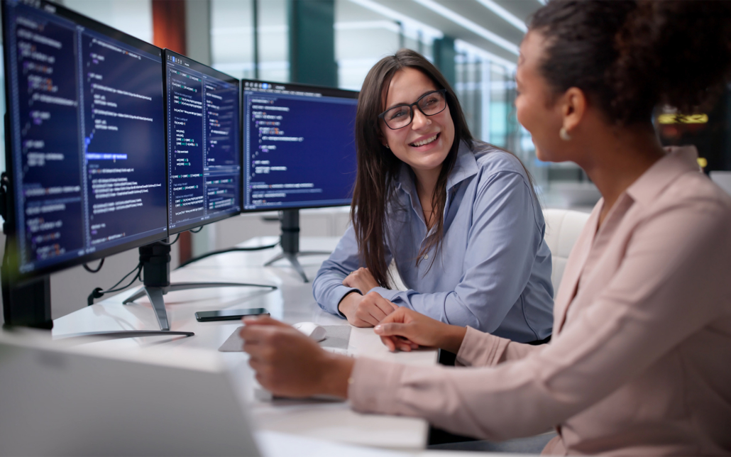 Workers Talking At Computer