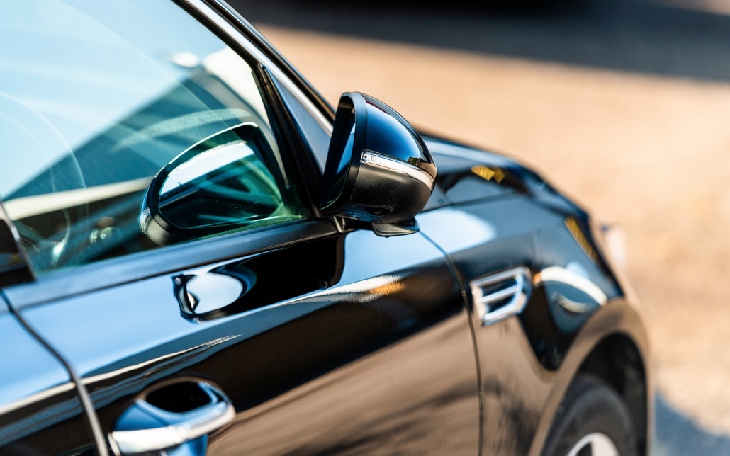 Side Door Of A Luxury Car Parked Outside On A Sunny Day